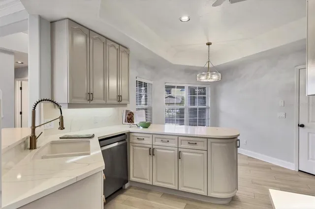 a kitchen with stainless steel appliances kitchen island granite countertop a refrigerator and a stove top oven
