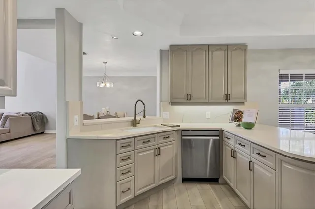a kitchen with a sink stove and cabinets