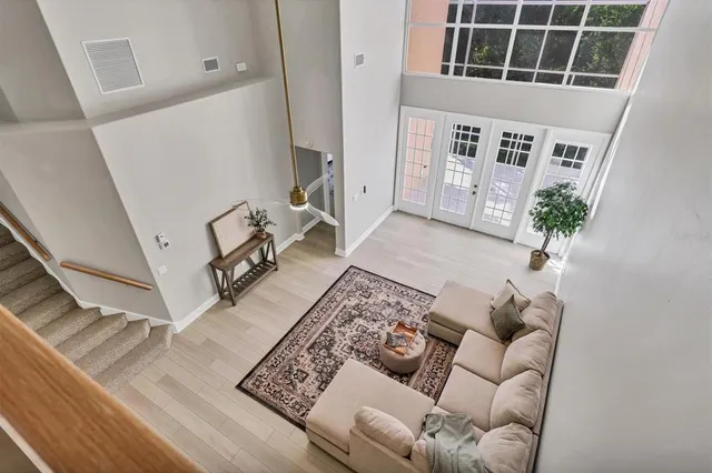 a view of a room with wooden floor and windows