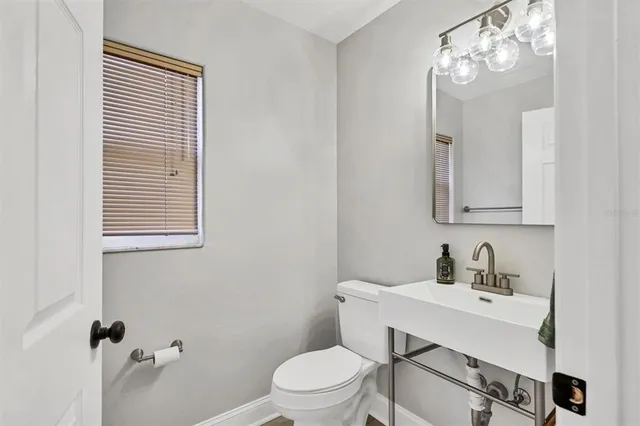 a view of patio with chairs and table under an umbrella