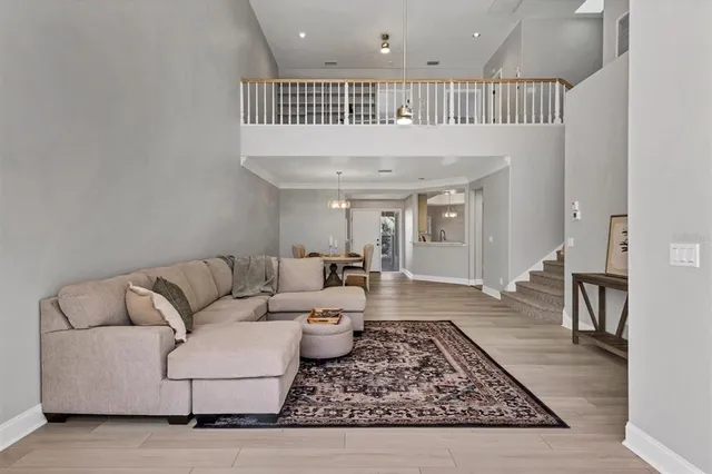 a living room with furniture and wooden floor