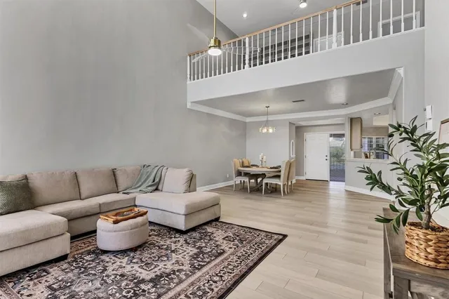 a view of a dining room with furniture wooden floor and a chandelier
