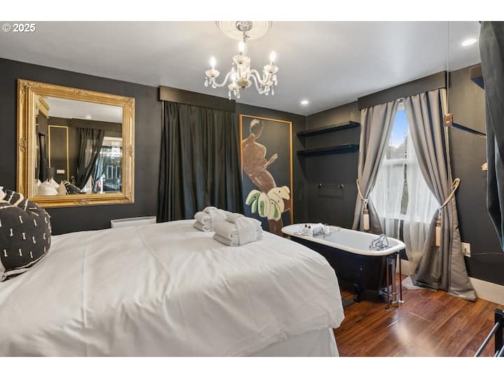 610 West Fourth Plain Boulevard Vancouver, WA 98660 - Photo 15 of 41 a bedroom with a large bed and a large mirror