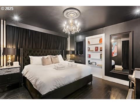 610 West Fourth Plain Boulevard Vancouver, WA 98660 - Photo 29 of 41 a bedroom with a bed and a chandelier