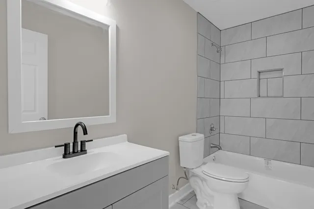 a bathroom with a sink toilet and a mirror