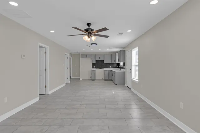 a view of a kitchen with a sink and a window