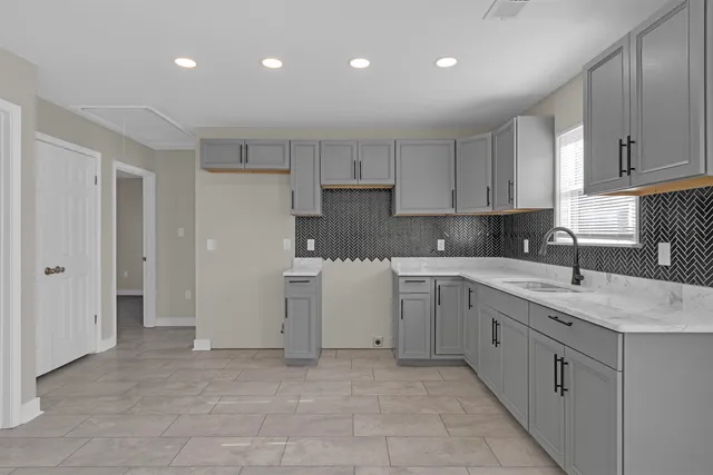 a kitchen with a sink window and cabinets