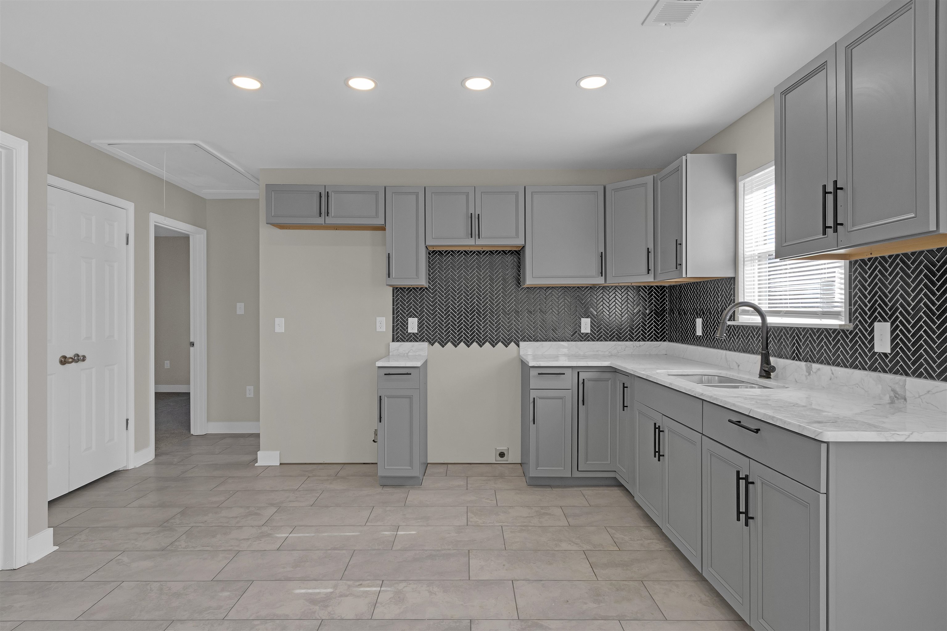 830 David Street Memphis, TN 38114 - Photo 7 of 16 a kitchen with a sink window and cabinets
