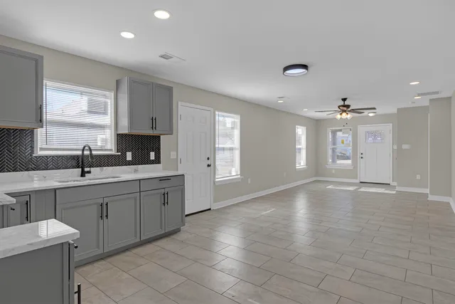 a view of a kitchen with a sink and a window