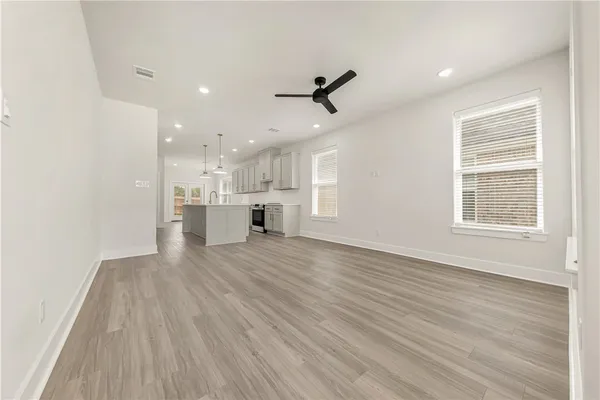 a view of a kitchen with a sink and wooden floor