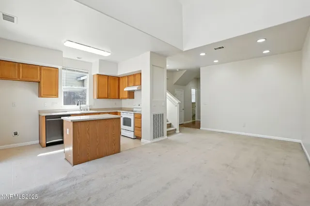 a view of a kitchen with a sink and dishwasher a stove top oven