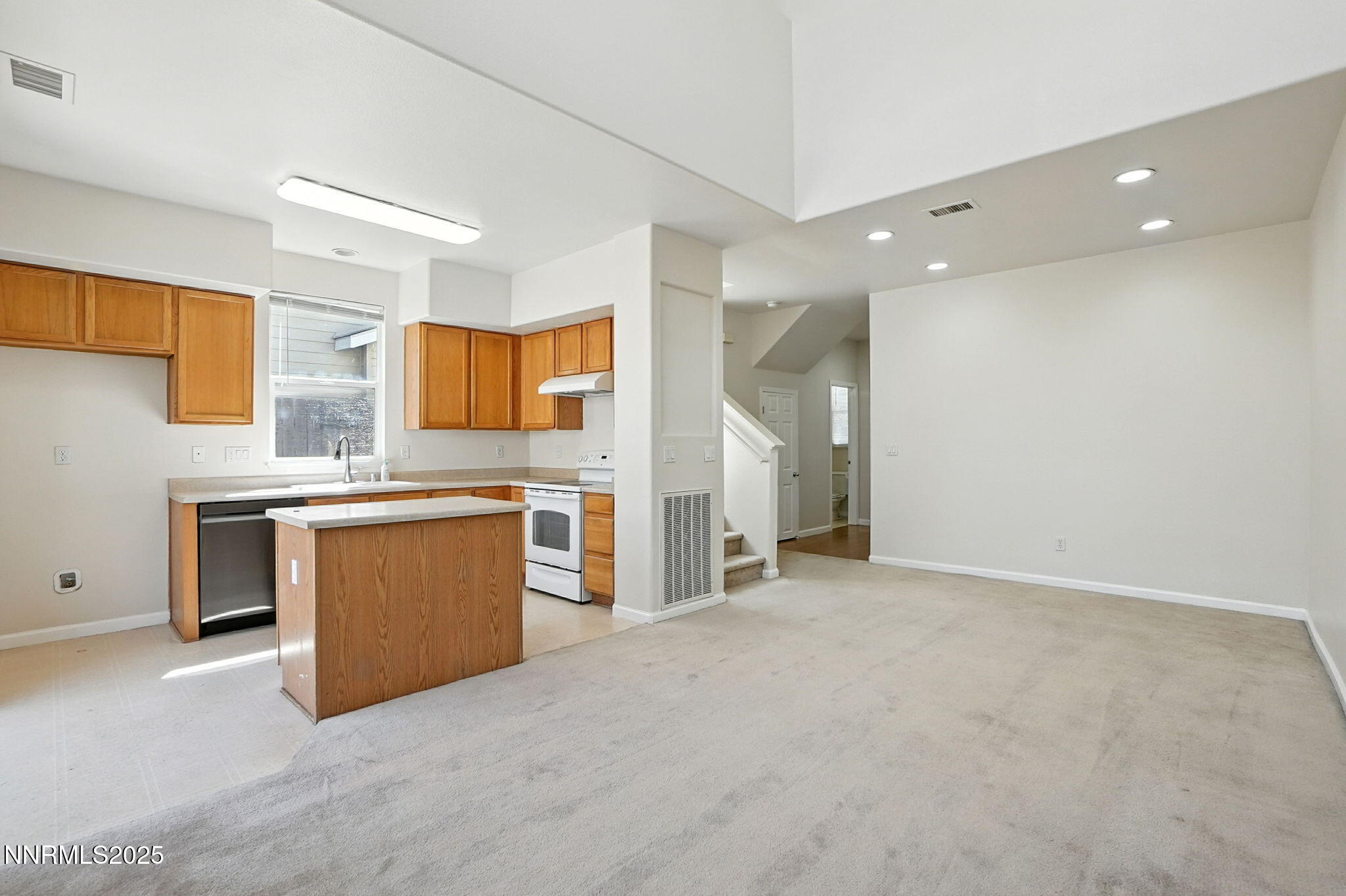 9248 Running Dog Circle Reno, NV 89506 - Photo 4 of 20 a view of a kitchen with a sink and dishwasher a stove top oven