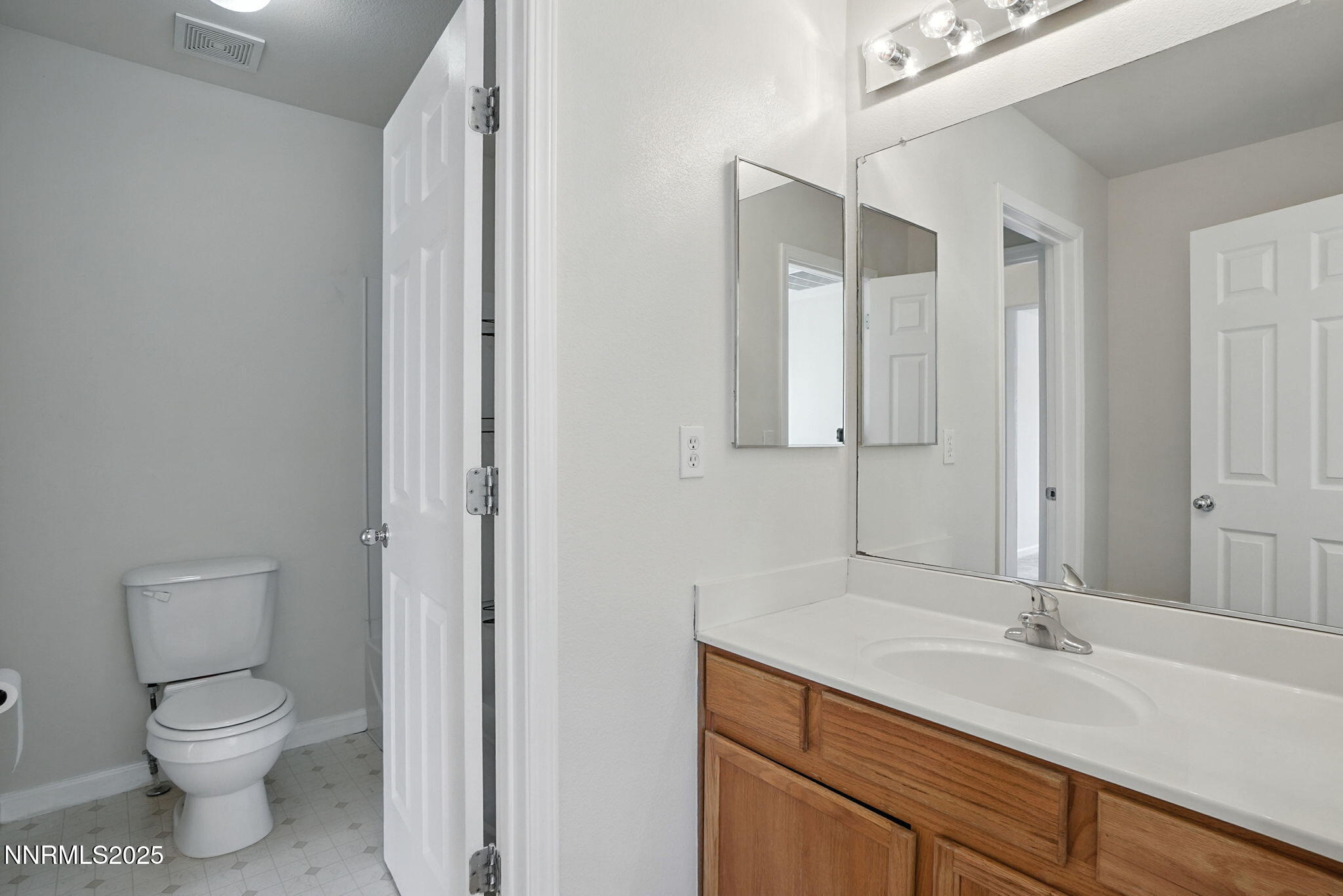 9248 Running Dog Circle Reno, NV 89506 - Photo 10 of 20 a bathroom with a toilet sink and mirror