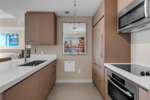 a kitchen with stainless steel appliances granite countertop a sink and a stove top oven