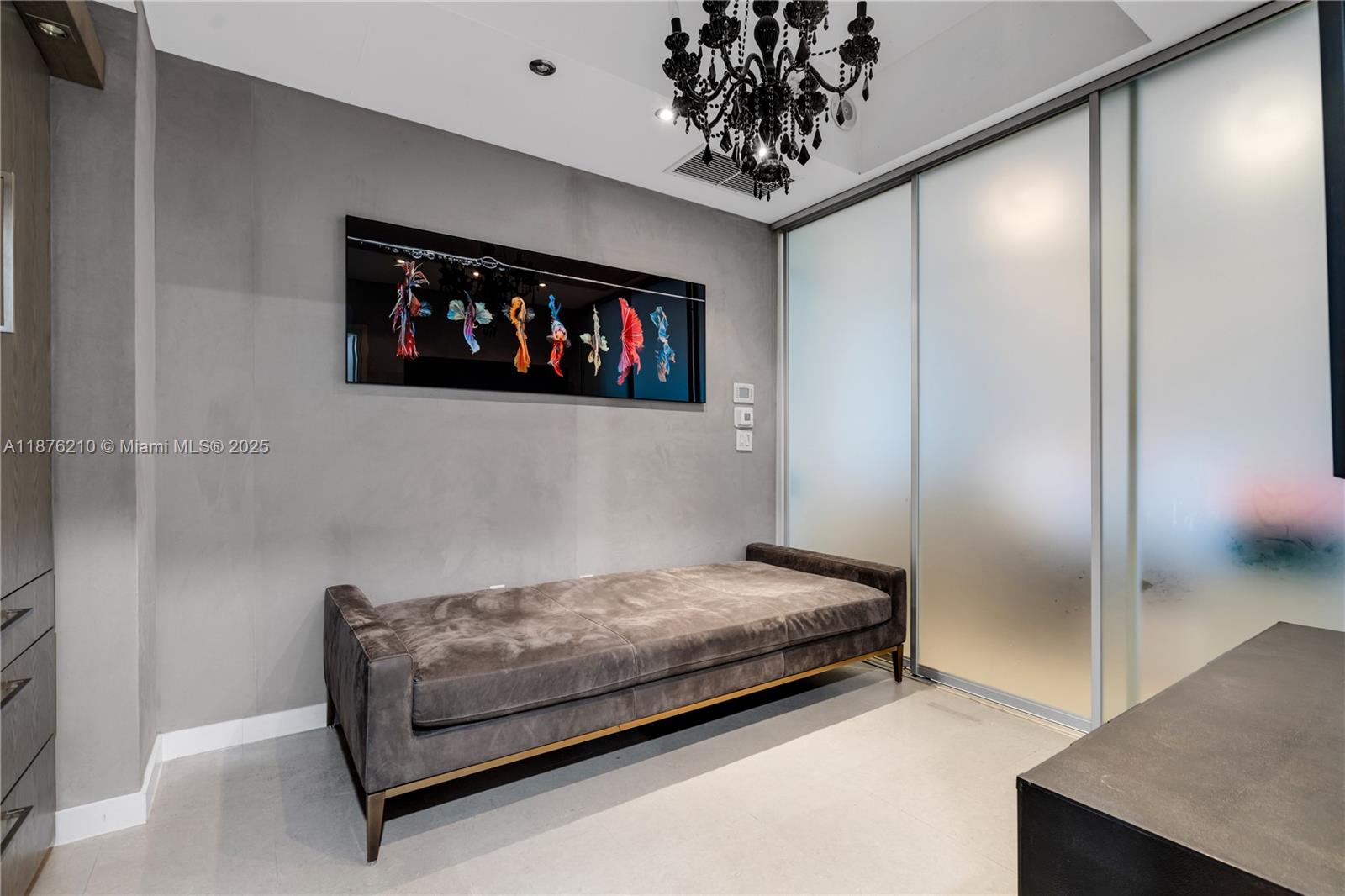 50 South Pointe Drive, Unit 606 Miami Beach, FL 33139 - Photo 15 of 36 a bedroom with a bed and a chandelier