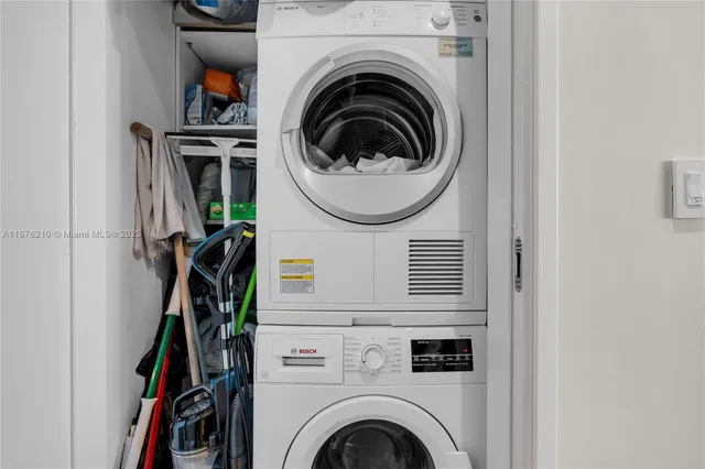 a view of a storage and utility room with washer and dryer
