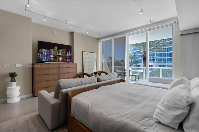 a bedroom with furniture and a flat screen tv