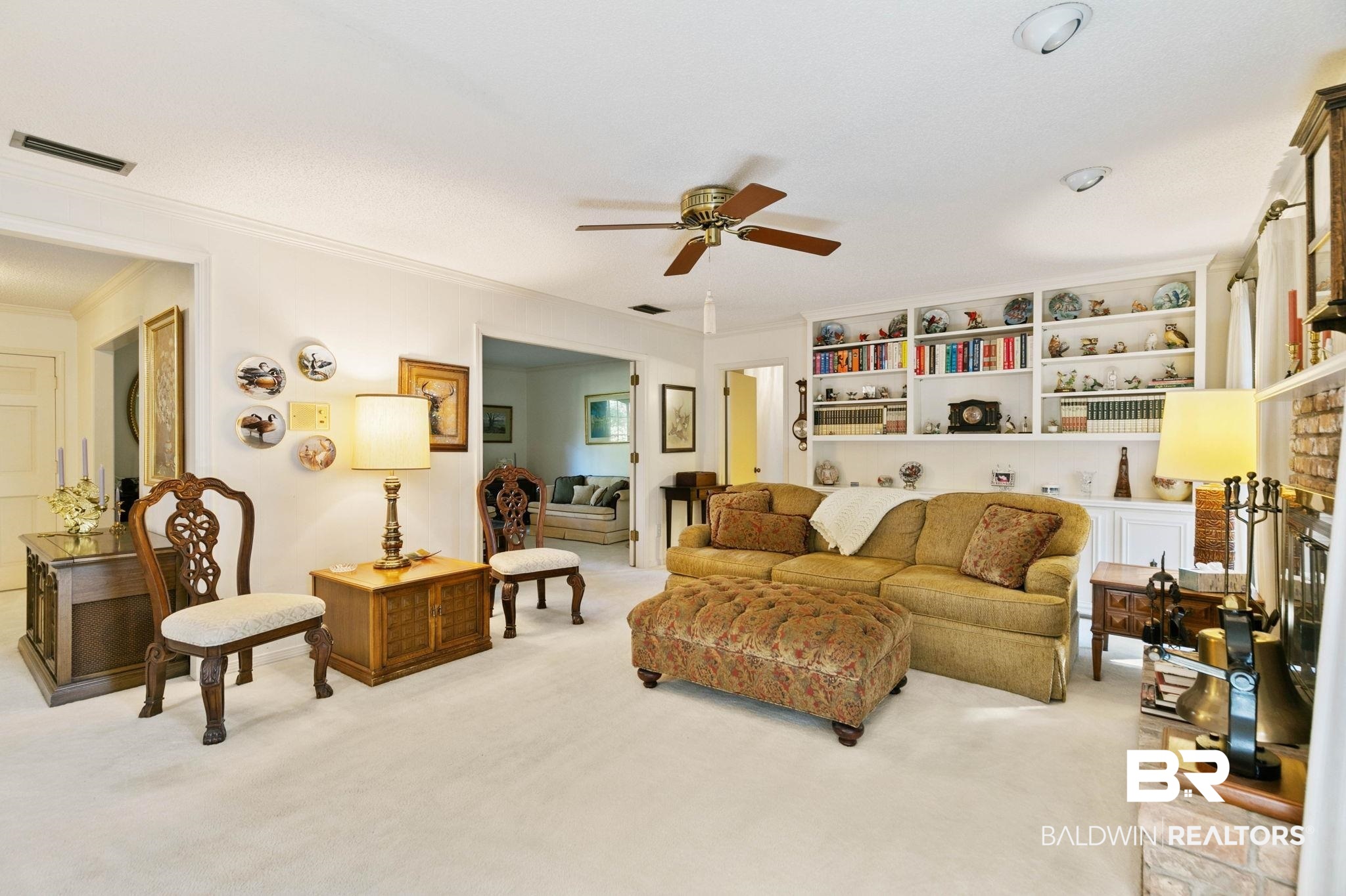 752 Evergreen Street Fairhope, AL 36532 - Photo 21 of 100 Living room with a ceiling fan, light colored carpet, a fireplace with raised hearth, and ornamental molding