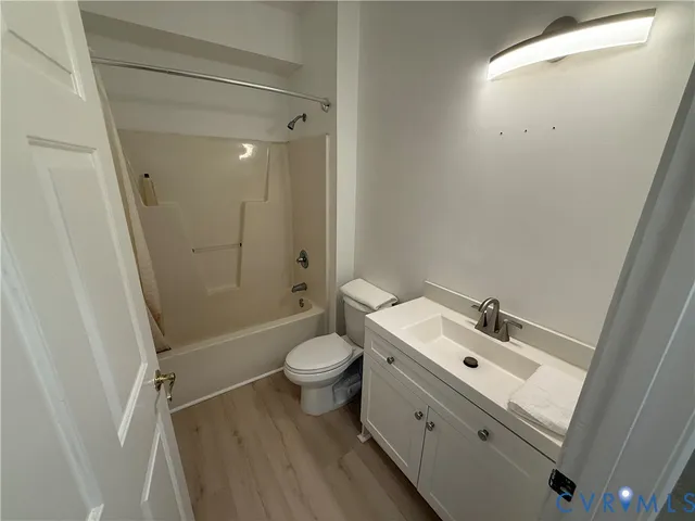 a bathroom with a sink mirror vanity and toilet