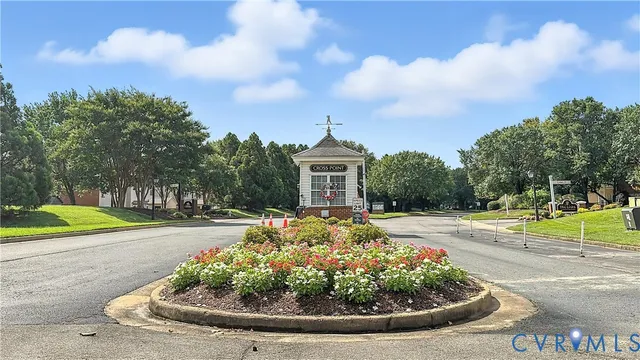 a view of a house with a big yard and large trees