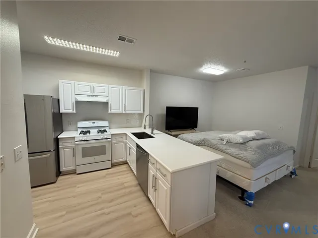 a kitchen with a refrigerator stove and a sink