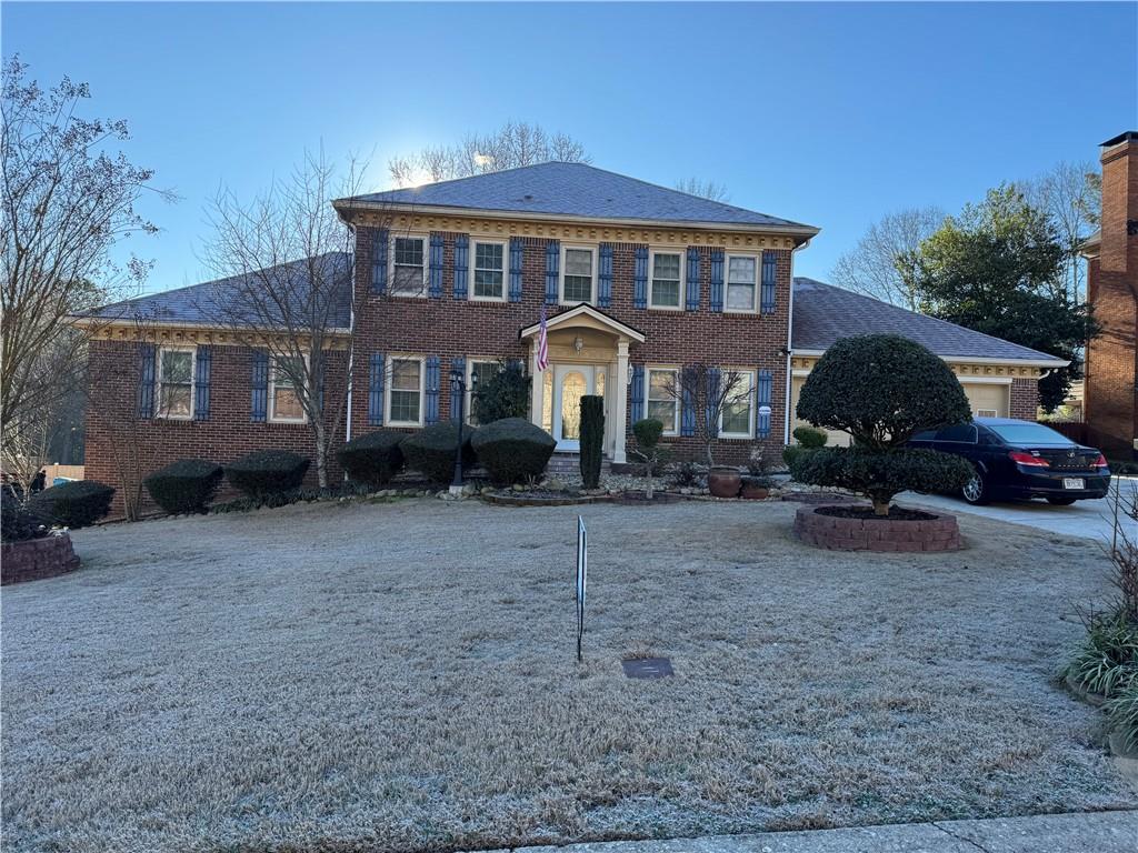 a front view of a house with a yard