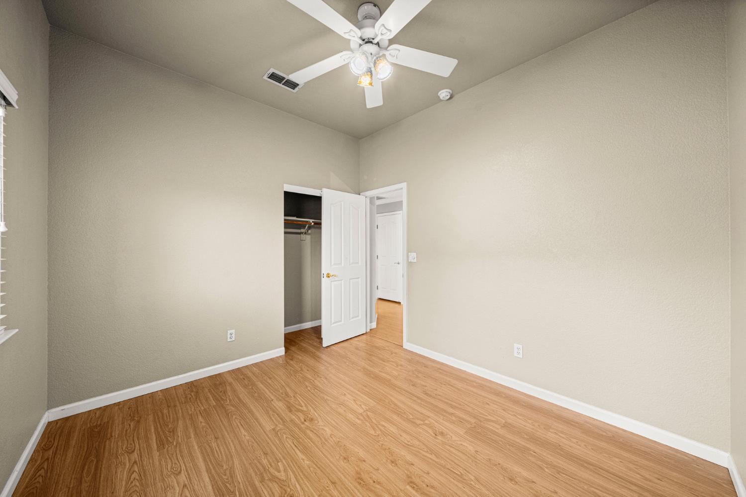 5116 Camden Road Rocklin, CA 95765 - Photo 21 of 31 a view of an empty room with window and wooden floor