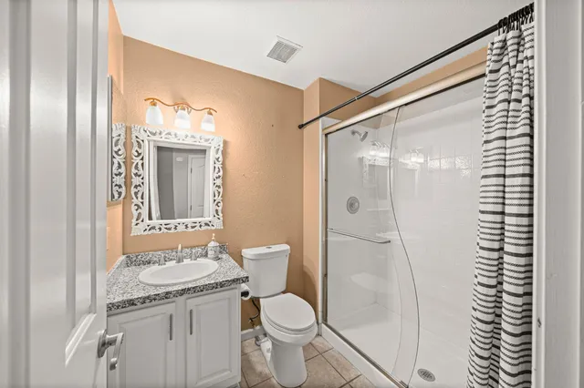 a kitchen with stainless steel appliances granite countertop a stove a refrigerator and a microwave