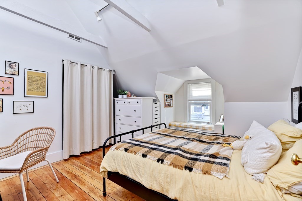 24-26 Crescent Street Cambridge, MA 02138 - Photo 12 of 36 a bedroom with a bed and dresser with mirror