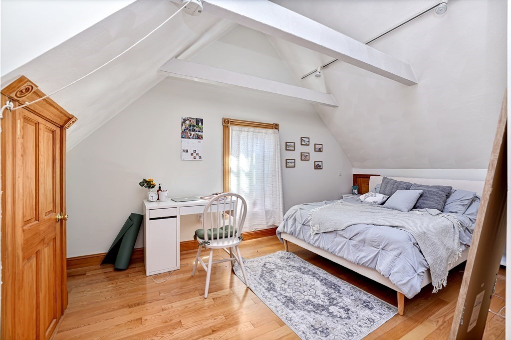 24-26 Crescent Street Cambridge, MA 02138 - Photo 15 of 36 a bedroom with a bed and wooden floor