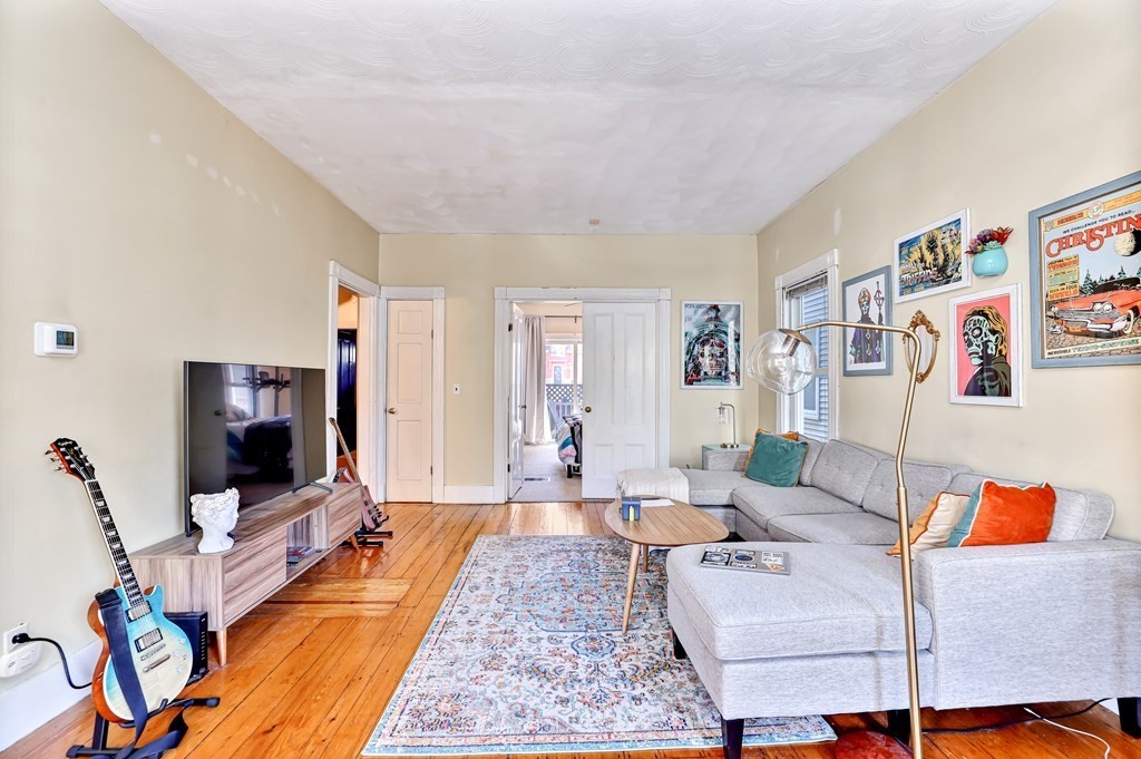 24-26 Crescent Street Cambridge, MA 02138 - Photo 18 of 36 a living room with furniture and a flat screen tv