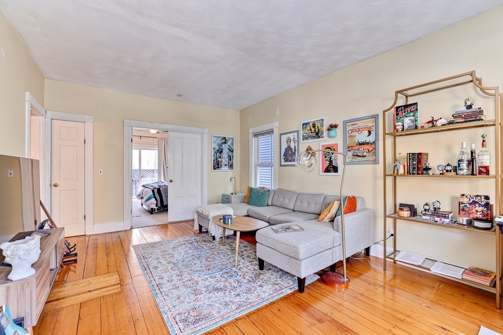 24-26 Crescent Street Cambridge, MA 02138 - Photo 19 of 36 a living room with furniture and wooden floor