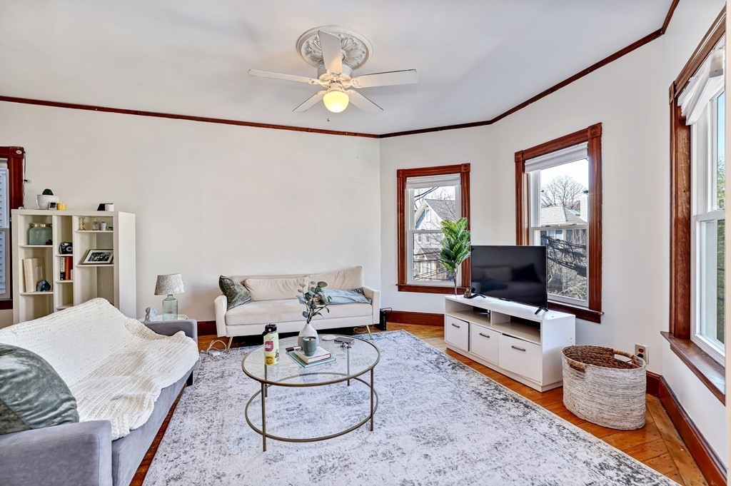 24-26 Crescent Street Cambridge, MA 02138 - Photo 2 of 36 a living room with furniture a flat screen tv and a window