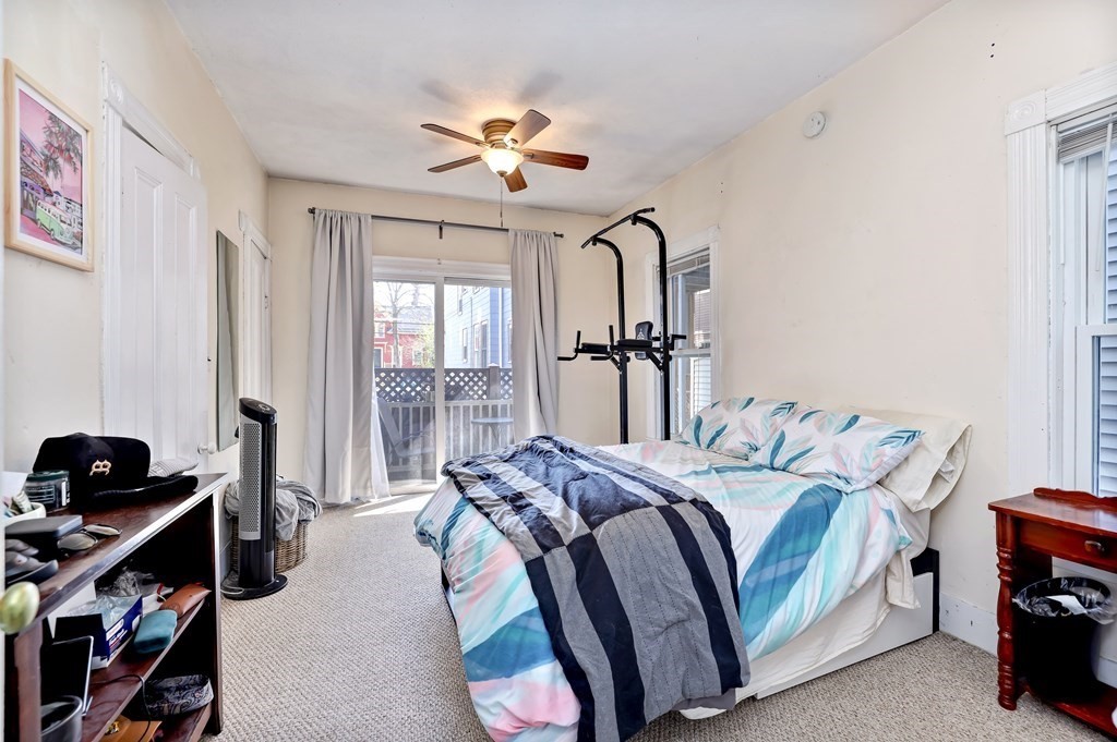 24-26 Crescent Street Cambridge, MA 02138 - Photo 23 of 36 a bedroom with a bed and a chandelier
