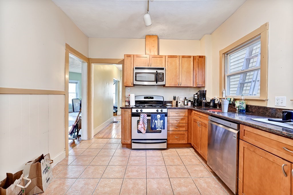 24-26 Crescent Street Cambridge, MA 02138 - Photo 26 of 36 a kitchen with stainless steel appliances granite countertop a stove sink and cabinets