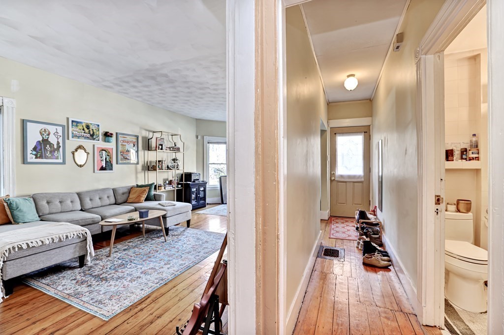 24-26 Crescent Street Cambridge, MA 02138 - Photo 27 of 36 a living room with furniture and a wooden floor