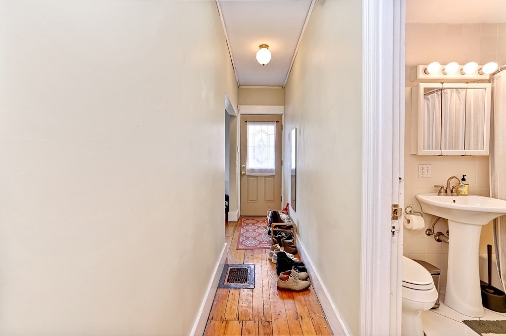 24-26 Crescent Street Cambridge, MA 02138 - Photo 28 of 36 a bathroom with a sink a toilet a window and vanity