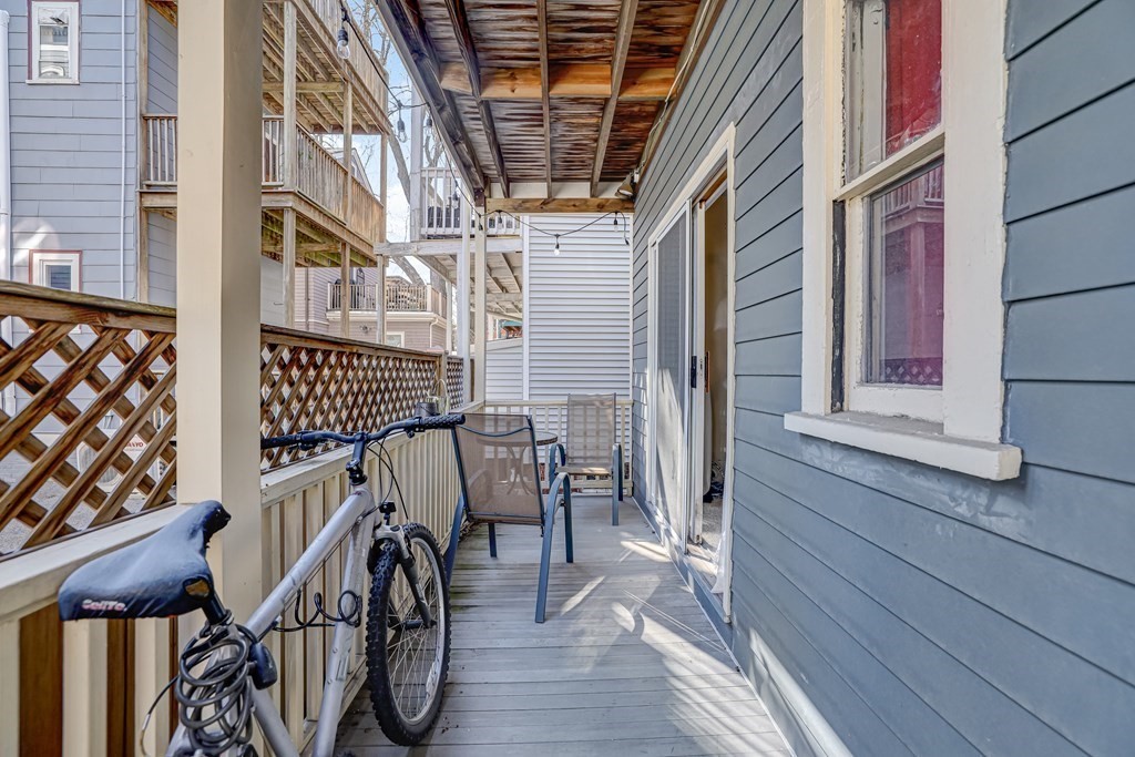 24-26 Crescent Street Cambridge, MA 02138 - Photo 30 of 36 a view of balcony with wooden floor and outdoor seating