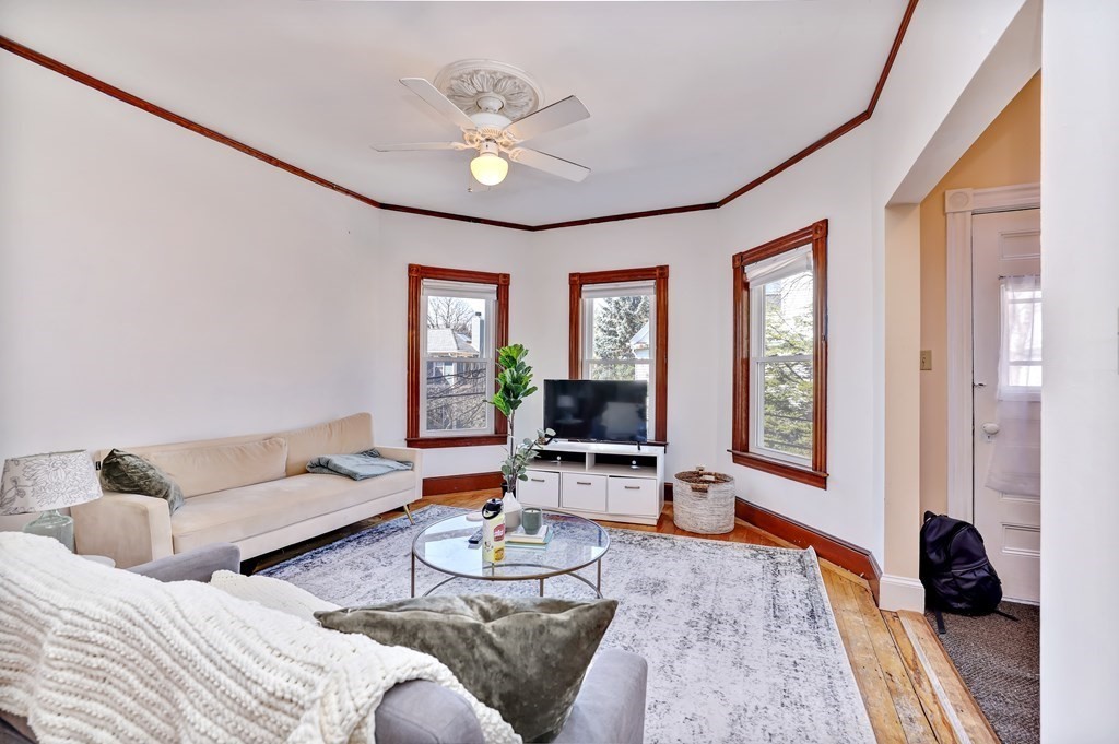 24-26 Crescent Street Cambridge, MA 02138 - Photo 3 of 36 a living room with furniture and a flat screen tv