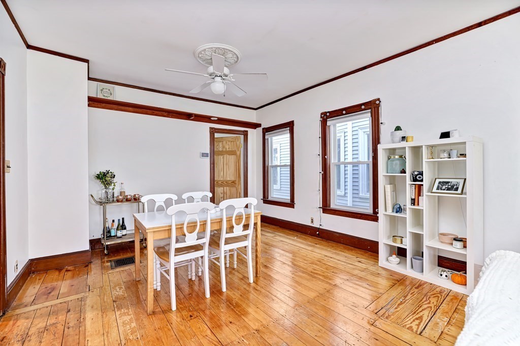 24-26 Crescent Street Cambridge, MA 02138 - Photo 4 of 36 a view of a dining room with furniture window and wooden floor