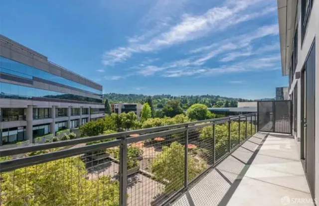 a living room with furniture a flat screen tv and a large window