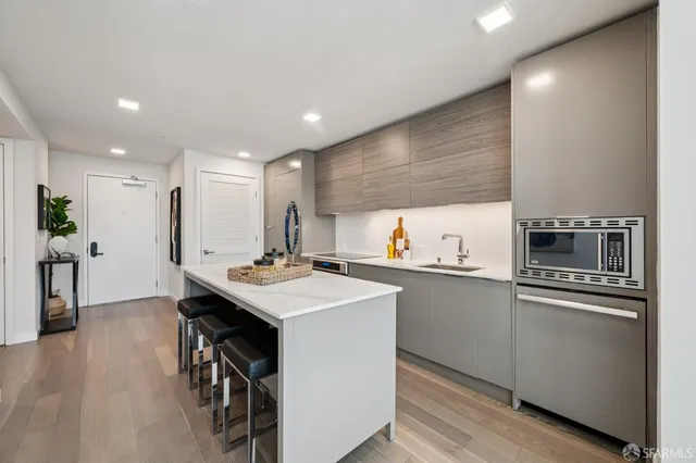 a kitchen with kitchen island a sink appliances and cabinets