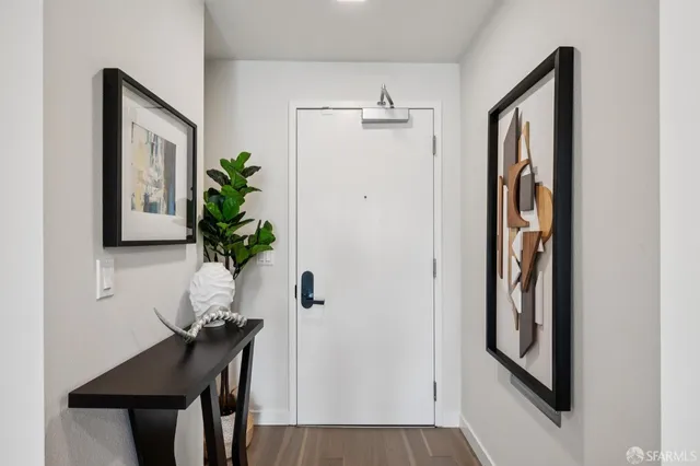 a view of a hallway with furniture and a potted plant