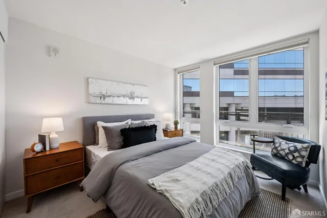 a bedroom with a bed and a night stand