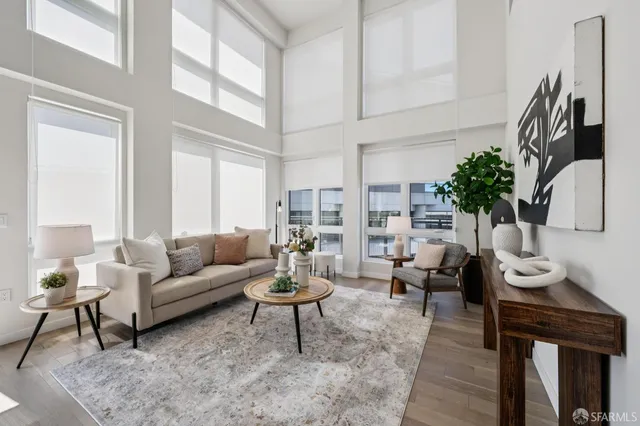 a living room with furniture wooden floor and a large window