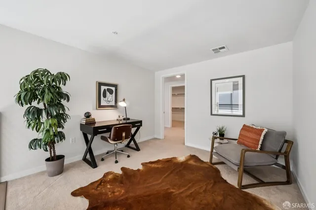 a bedroom with a bed and glass walk in closet