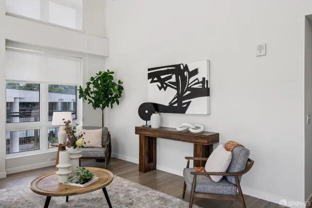 a living room with furniture and a potted plant