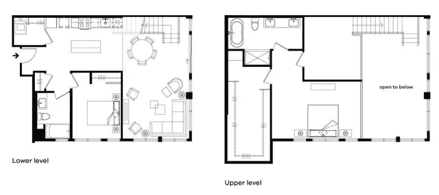 a front view of building with outdoor seating and plants