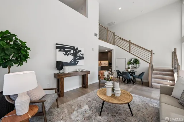 a living room with furniture and a potted plant