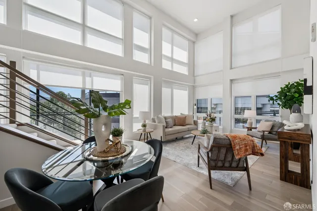 a living room with furniture and potted plants